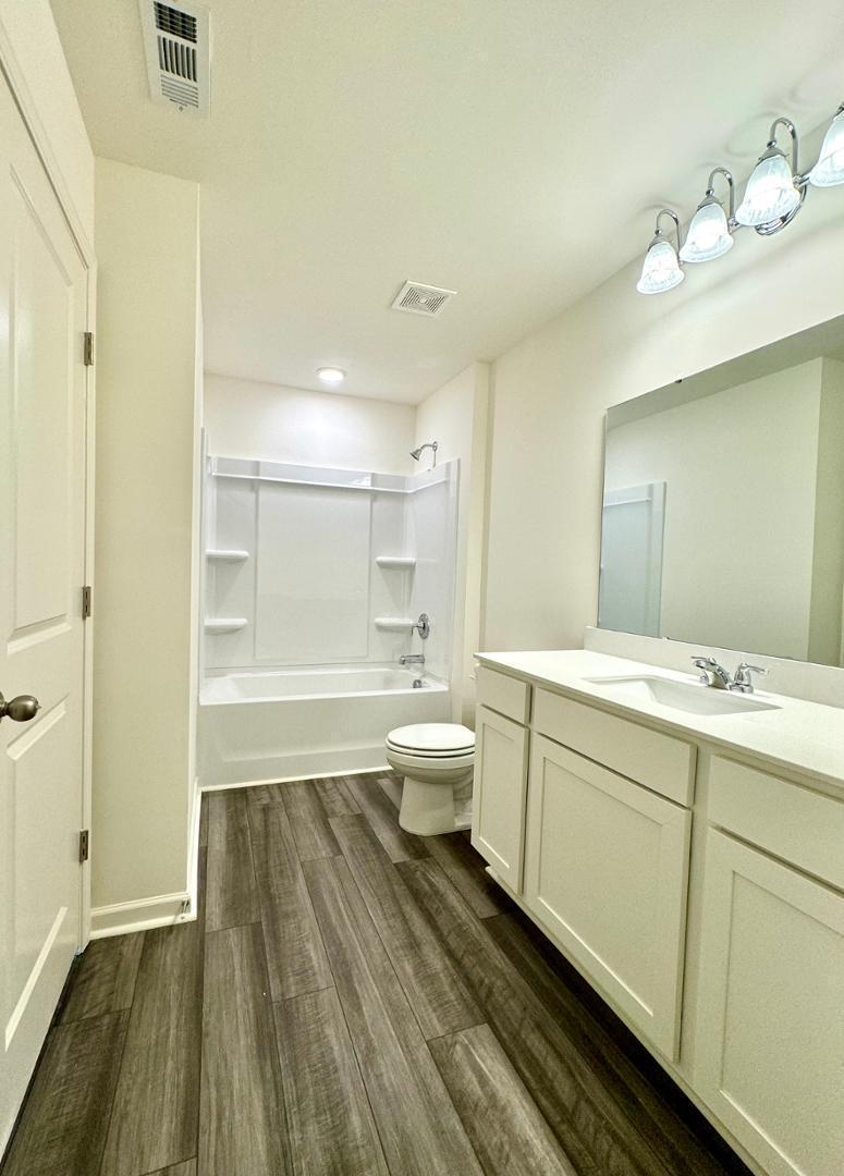 3117 Primo Drive Durham, NC 27704 - Photo 14 of 23 a bathroom with a sink a toilet and shower