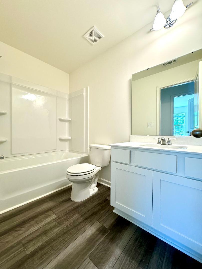 3117 Primo Drive Durham, NC 27704 - Photo 17 of 23 a bathroom with a toilet a sink and bathtub