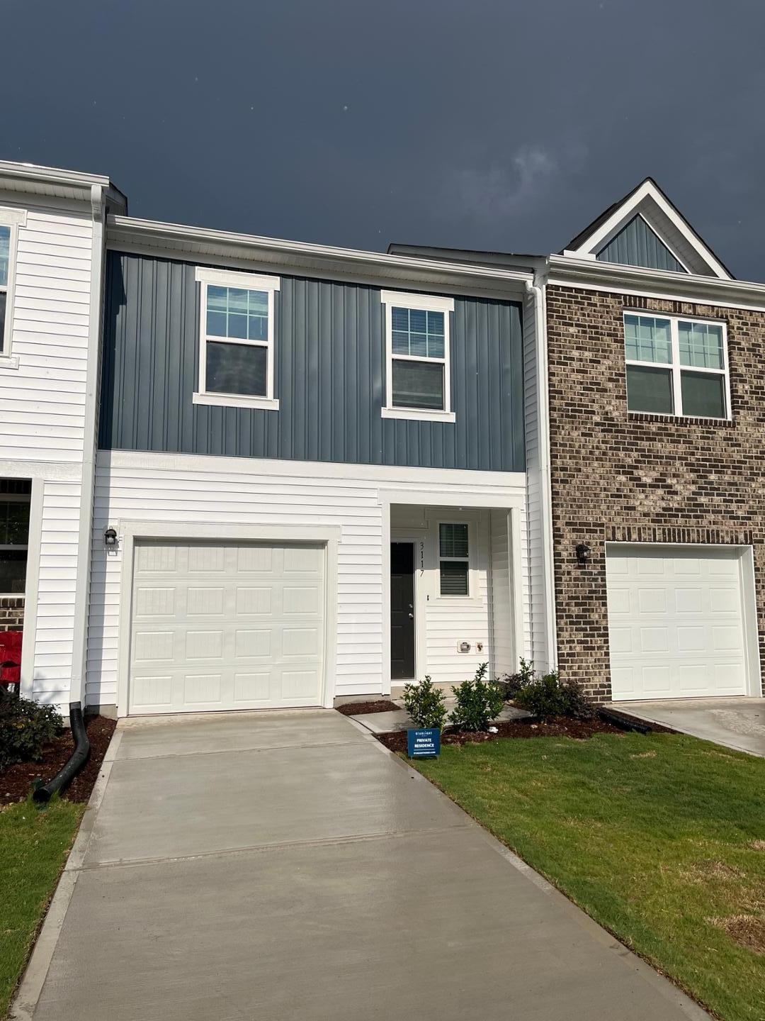 3117 Primo Drive Durham, NC 27704 - Photo 3 of 23 a front view of a house with a garden and garage