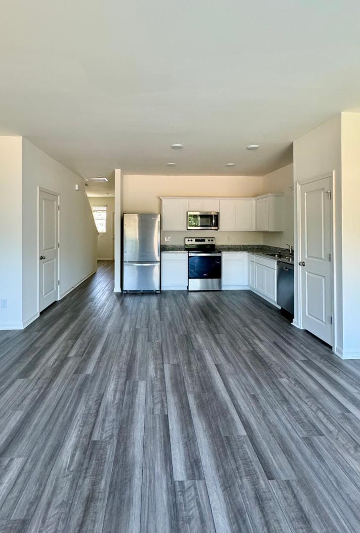 3117 Primo Drive Durham, NC 27704 - Photo 6 of 23 a kitchen with stainless steel appliances wooden floors and view living room