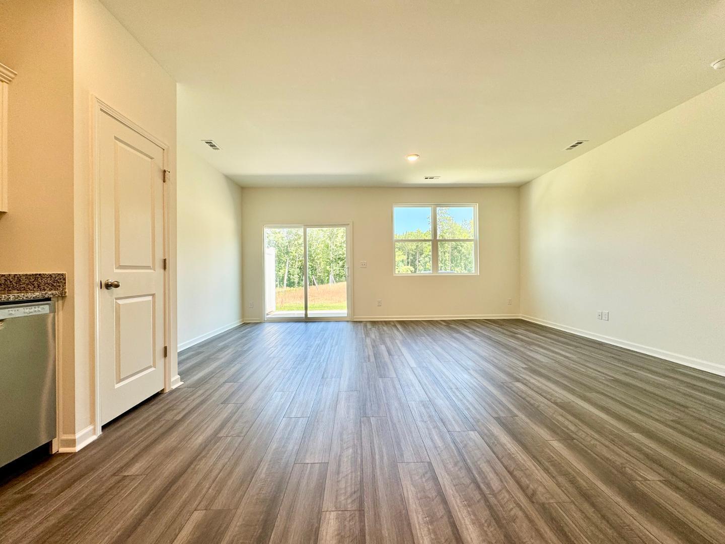 3117 Primo Drive Durham, NC 27704 - Photo 7 of 23 an empty room with wooden floor and windows