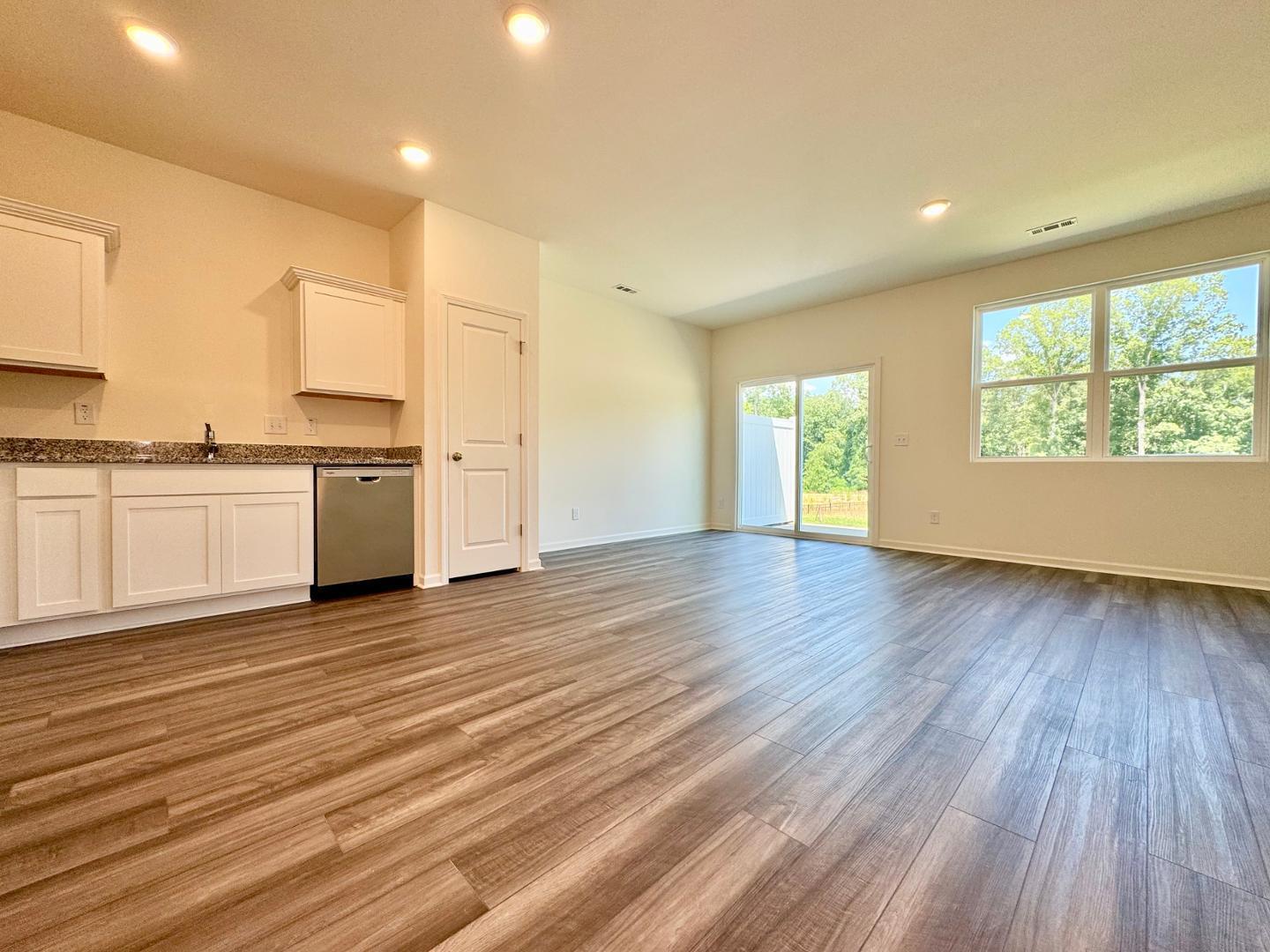 3117 Primo Drive Durham, NC 27704 - Photo 8 of 23 an empty room with wooden floor and windows