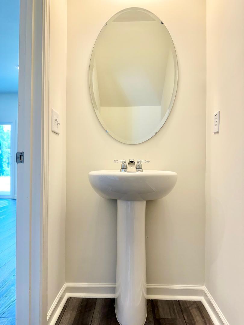 3117 Primo Drive Durham, NC 27704 - Photo 9 of 23 a bathroom with a sink a mirror and a toilet
