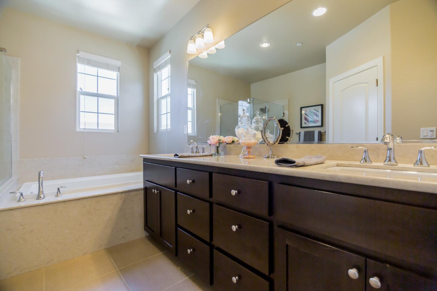 328 Gerald Circle Milpitas, CA 95035 - Photo 15 of 33 a bathroom with double vanity sinks double vanity tub and a window