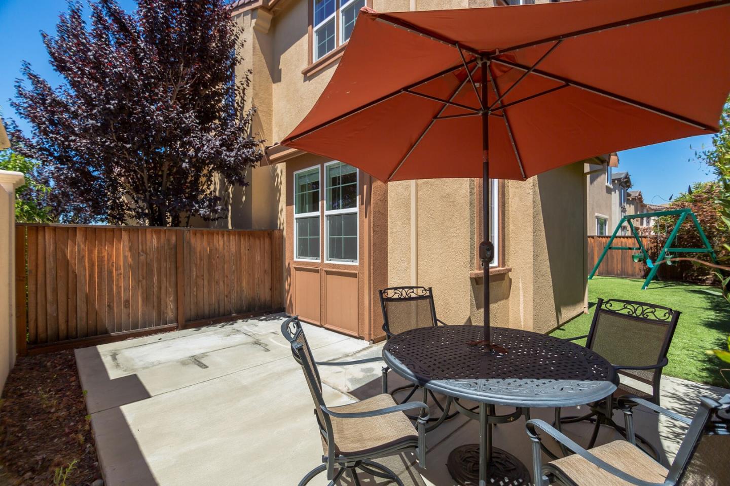 328 Gerald Circle Milpitas, CA 95035 - Photo 24 of 33 a patio with a table and chairs under an umbrella