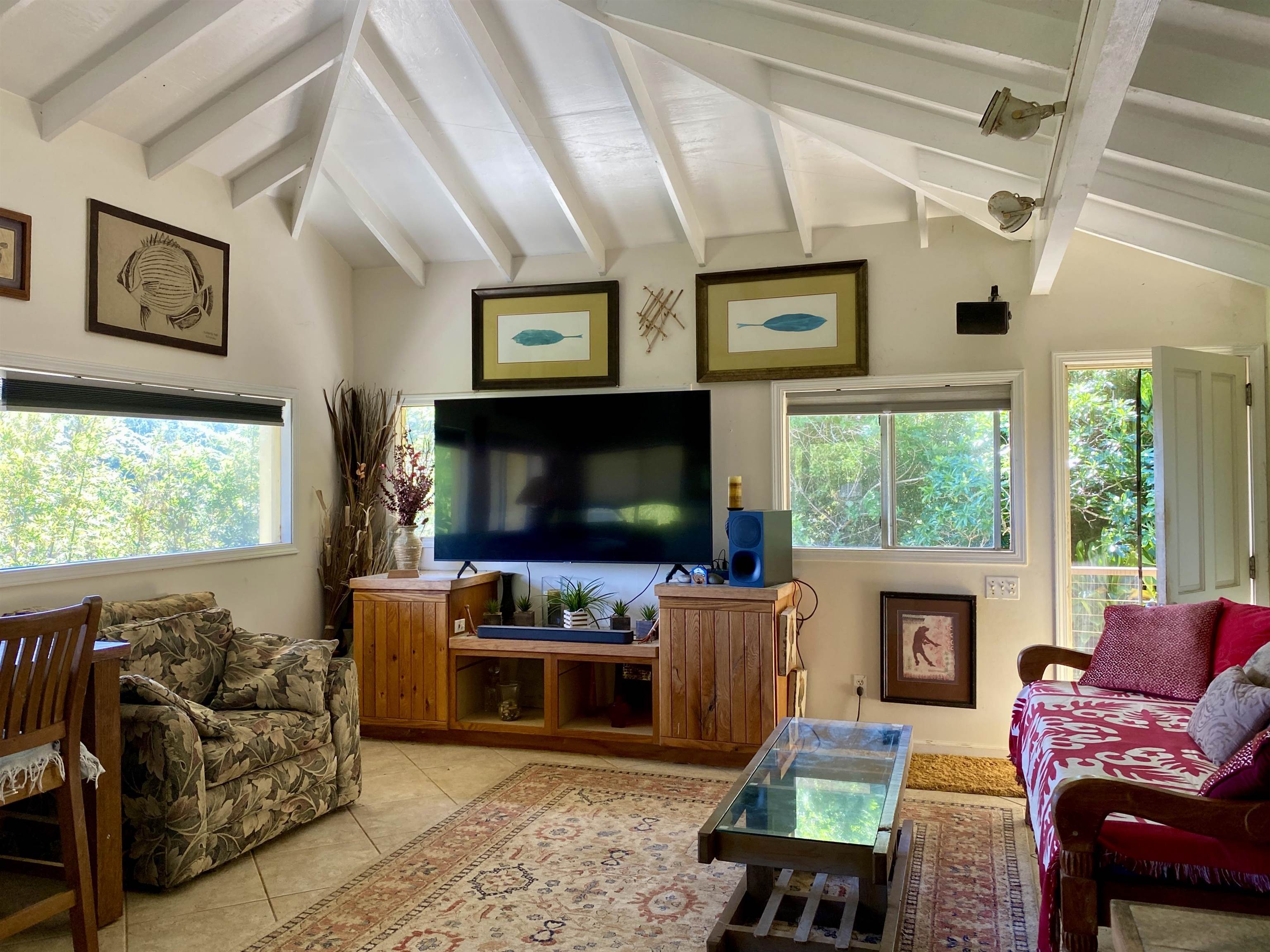 700 Honopou Road, Unit 700 HONOPOU RD Haiku, HI 96708 - Photo 17 of 50 a living room with furniture a flat screen tv and a fireplace