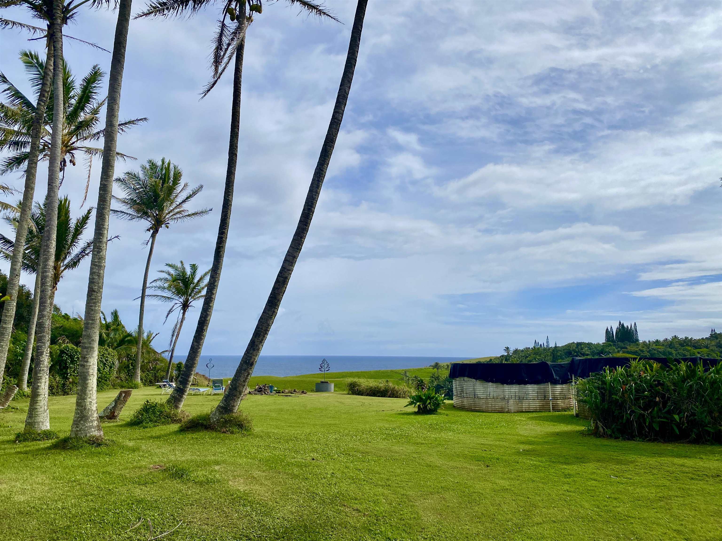 700 Honopou Road, Unit 700 HONOPOU RD Haiku, HI 96708 - Photo 30 of 50 a view of a golf ground with a big yard