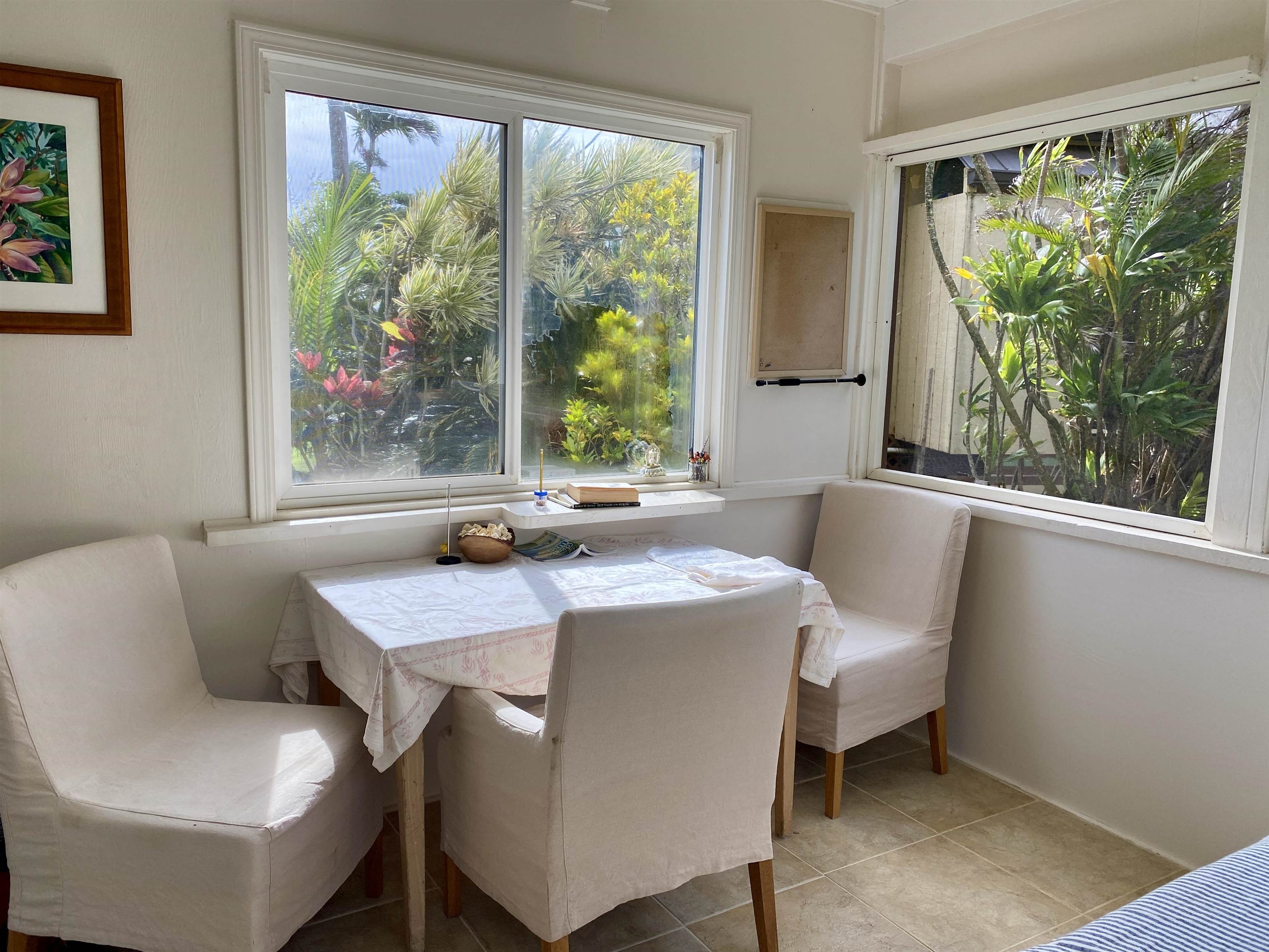 700 Honopou Road, Unit 700 HONOPOU RD Haiku, HI 96708 - Photo 35 of 50 a dining room with furniture a large window and a rug