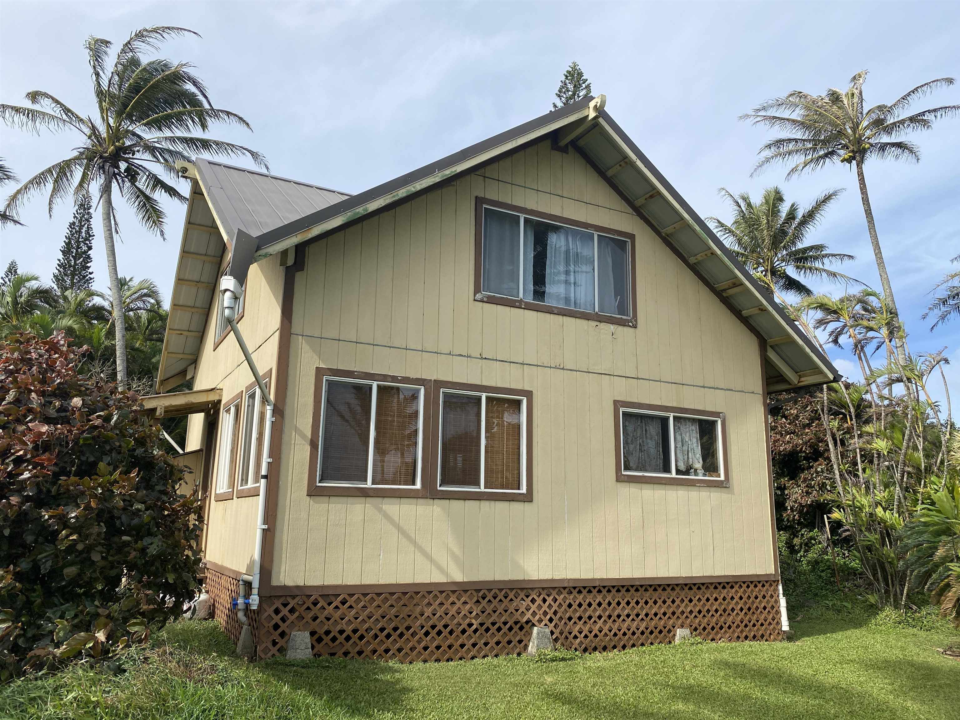 700 Honopou Road, Unit 700 HONOPOU RD Haiku, HI 96708 - Photo 4 of 50 a front view of a house with a yard and garage