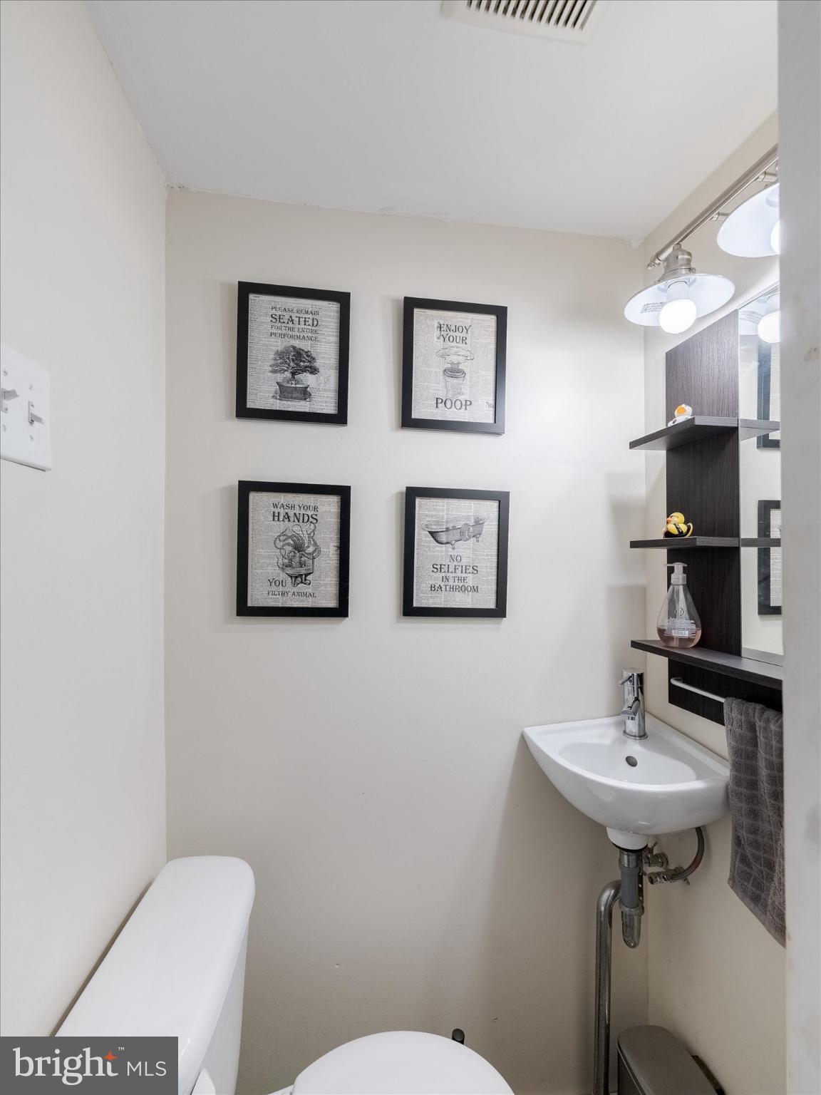 908 West Amosland Road Prospect Park, PA 19076 - Photo 11 of 35 a bathroom with a toilet a sink and mirror