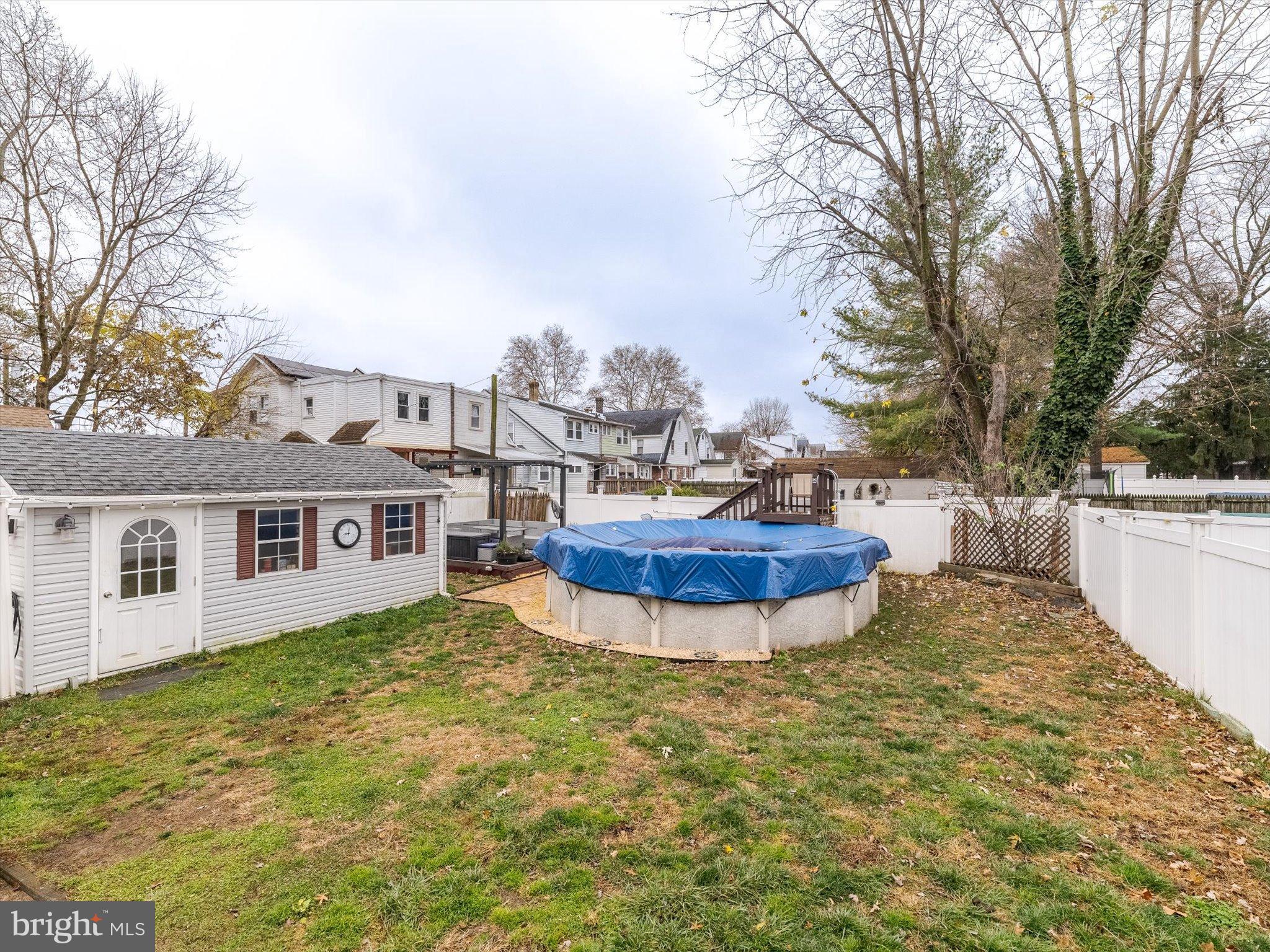 908 West Amosland Road Prospect Park, PA 19076 - Photo 27 of 35 a view of a white house with a large pool and a yard