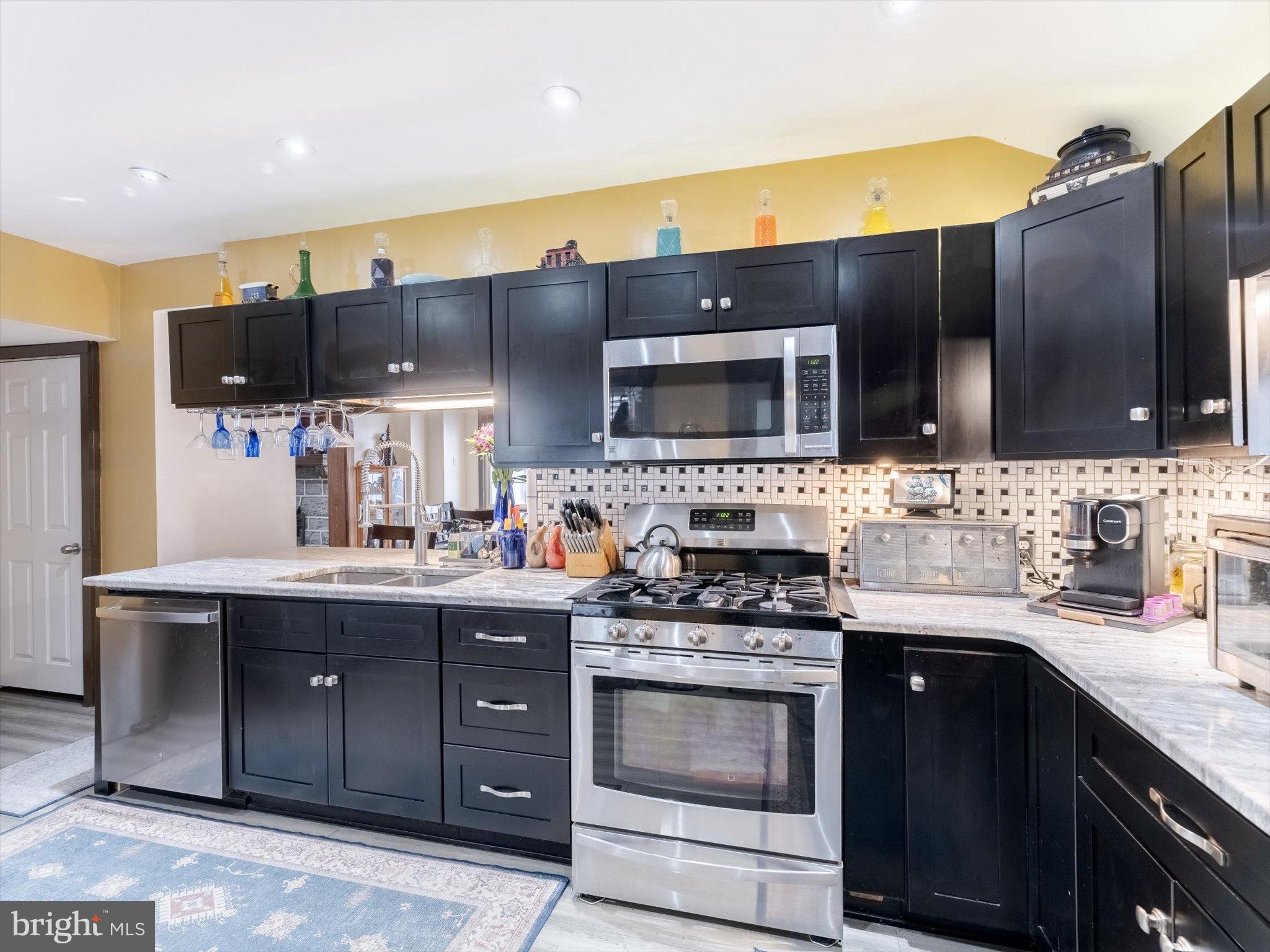 908 West Amosland Road Prospect Park, PA 19076 - Photo 4 of 35 Modern kitchen with sleek black cabinetry.