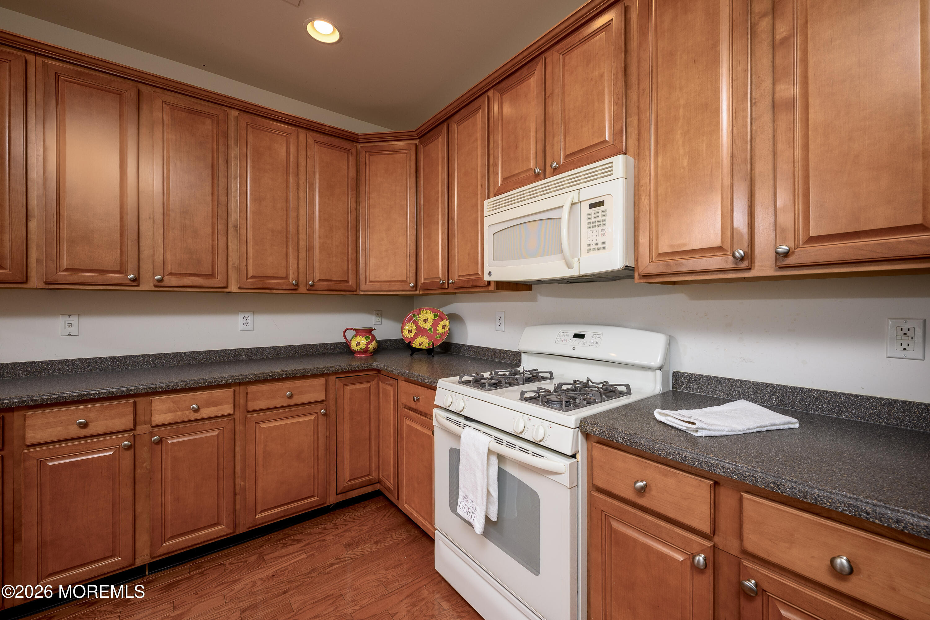33 Cromwell Lane Jackson, NJ 08527 - Photo 11 of 32 a kitchen with granite countertop cabinets and stainless steel appliances