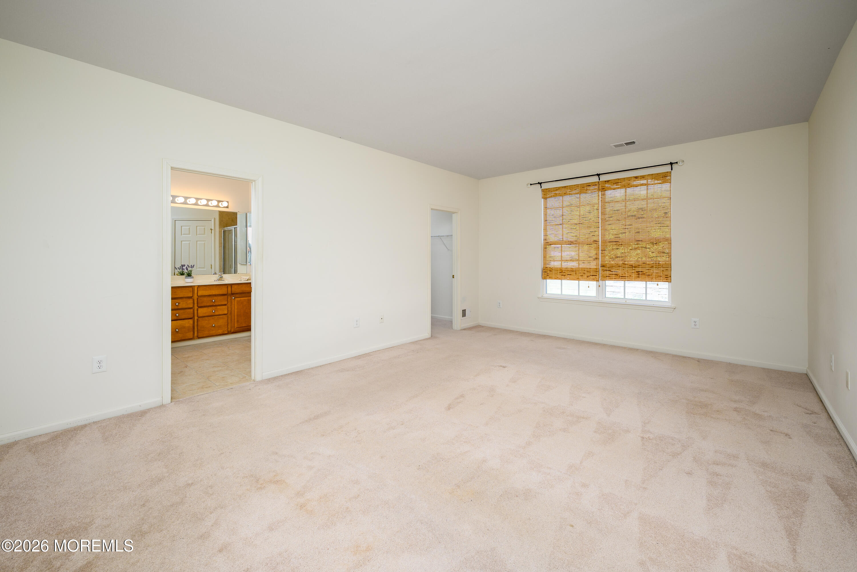 33 Cromwell Lane Jackson, NJ 08527 - Photo 13 of 32 an empty room with a window and a kitchen