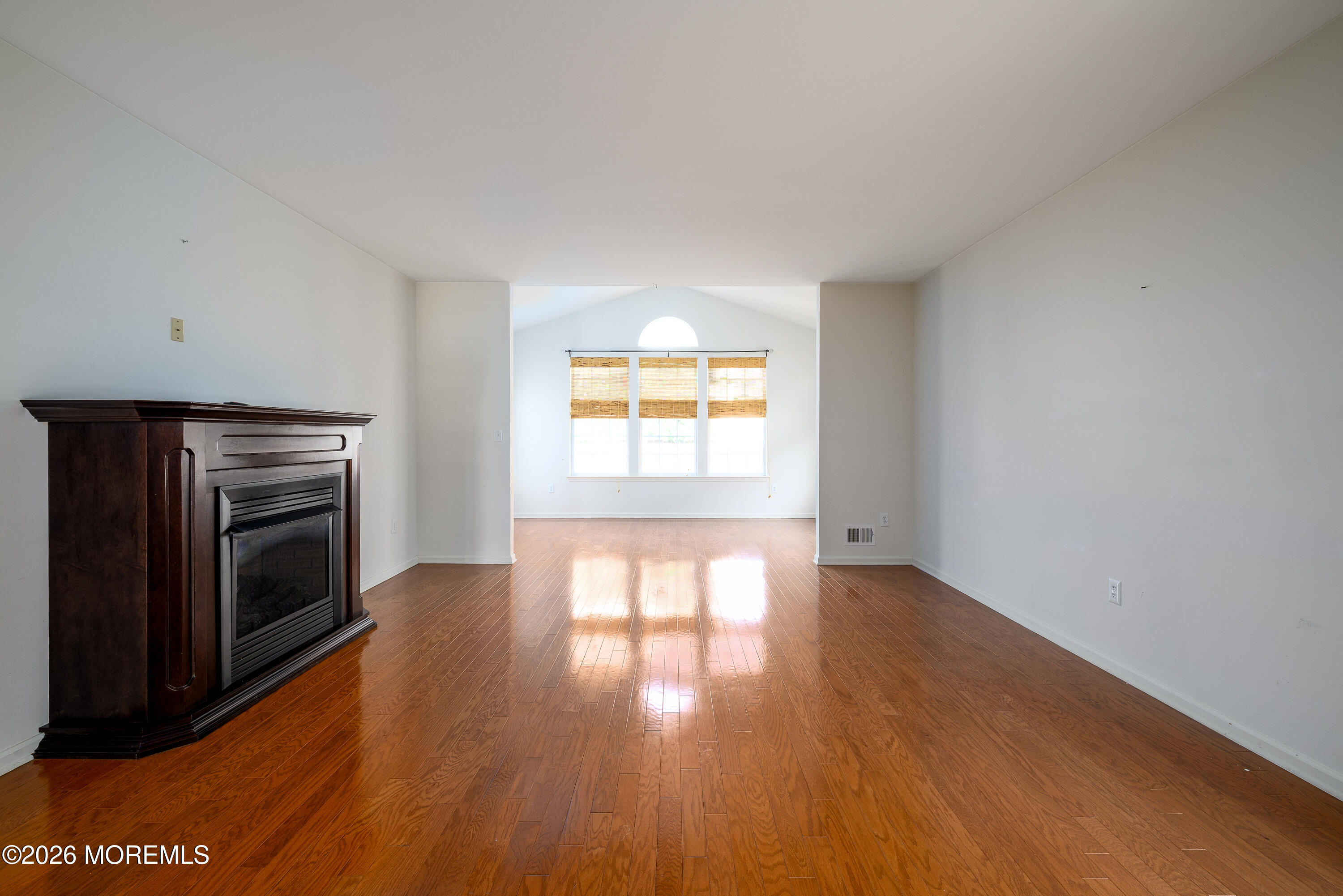 33 Cromwell Lane Jackson, NJ 08527 - Photo 6 of 32 a view of empty room with a fireplace and wooden floor