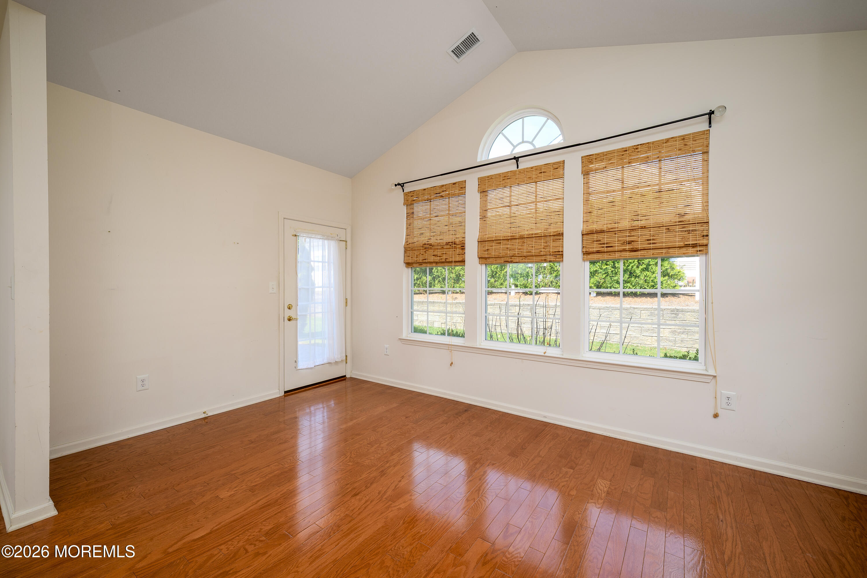 33 Cromwell Lane Jackson, NJ 08527 - Photo 8 of 32 a view of an empty room with wooden floor and a window