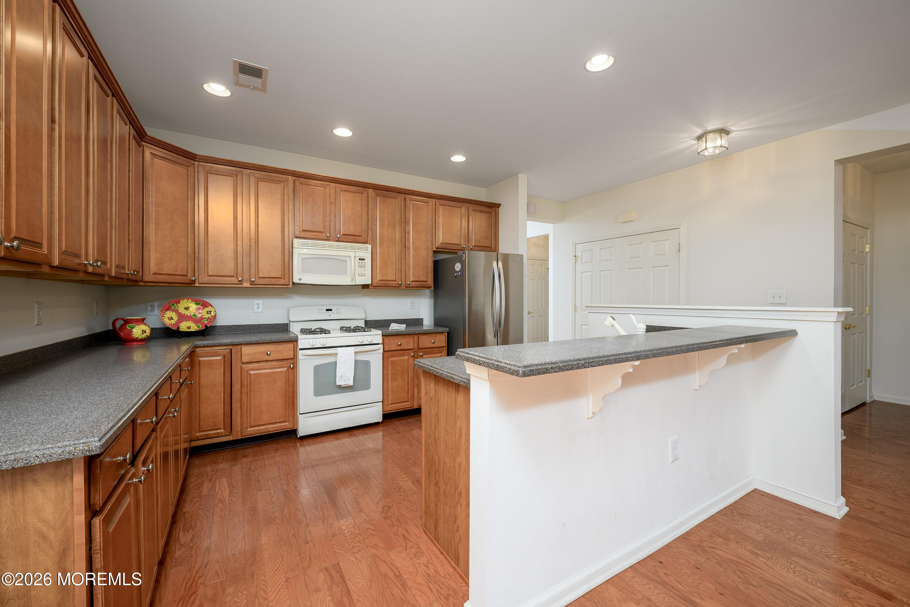 33 Cromwell Lane Jackson, NJ 08527 - Photo 9 of 32 a kitchen with stainless steel appliances granite countertop a stove a sink and a refrigerator