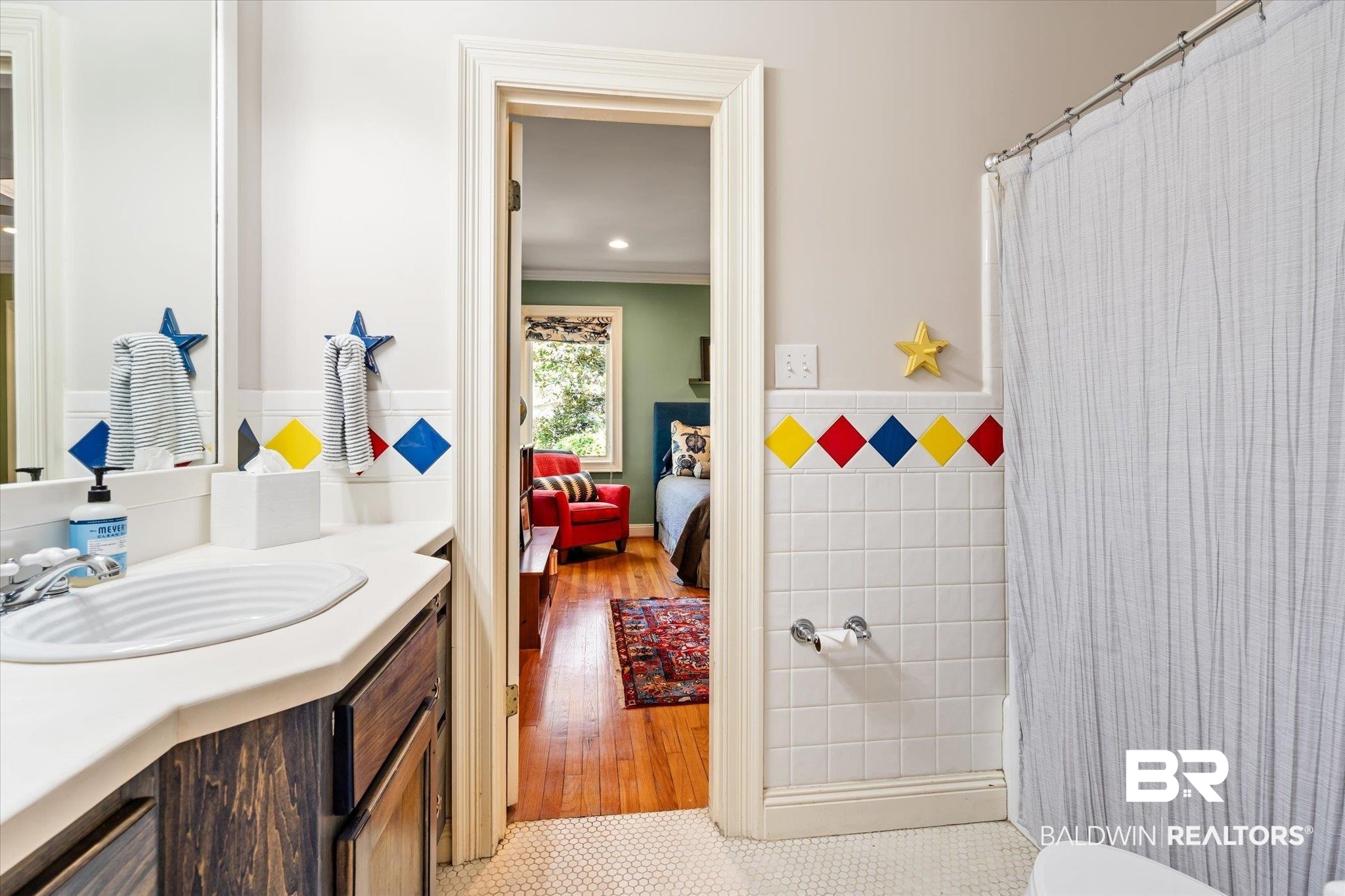 4 Kingsway Mobile, AL 36608 - Photo 28 of 44 Ensuite bathroom featuring vanity, a shower with curtain, crown molding, tile walls, and connected bathroom