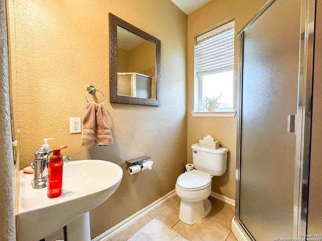 a bathroom with a toilet sink and a mirror