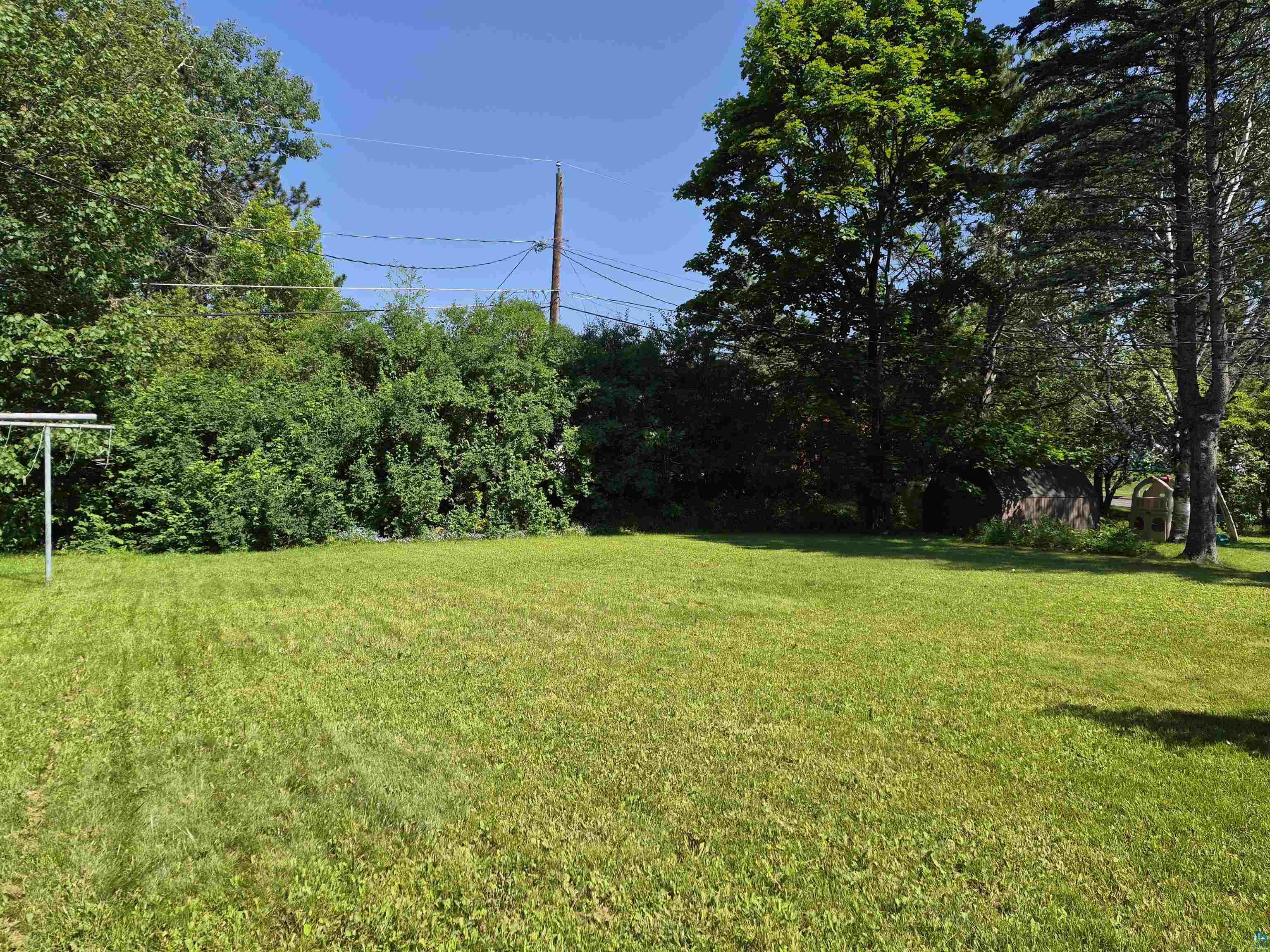 2109 West 22nd Street Duluth, MN 55811 - Photo 5 of 29 Expansive green lawn surrounded by mature trees and shrubs providing privacy.