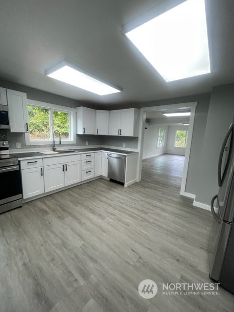 1244 Cedar Street Raymond, WA 98577 - Photo 13 of 25 a large kitchen with lots of counter space and wooden floor