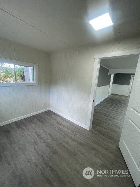 1244 Cedar Street Raymond, WA 98577 - Photo 17 of 25 an empty room with wooden floor and windows