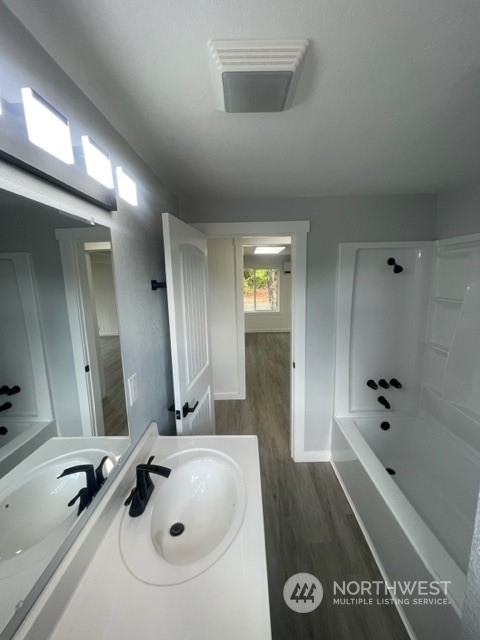 1244 Cedar Street Raymond, WA 98577 - Photo 18 of 25 a bathroom with a tub sink and mirror