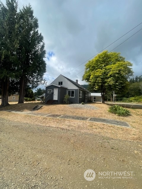 1244 Cedar Street Raymond, WA 98577 - Photo 2 of 25 a front view of a house with a yard