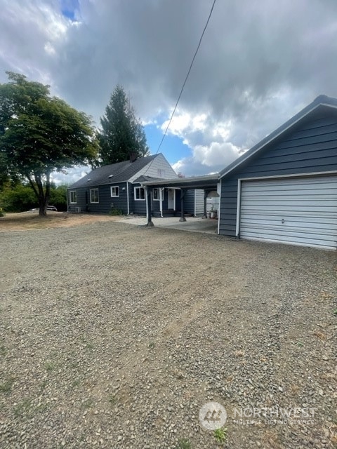 1244 Cedar Street Raymond, WA 98577 - Photo 3 of 25 a view of a house with a yard and garage