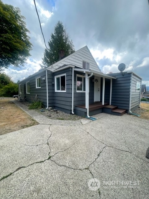 1244 Cedar Street Raymond, WA 98577 - Photo 4 of 25 a front view of a house with a yard