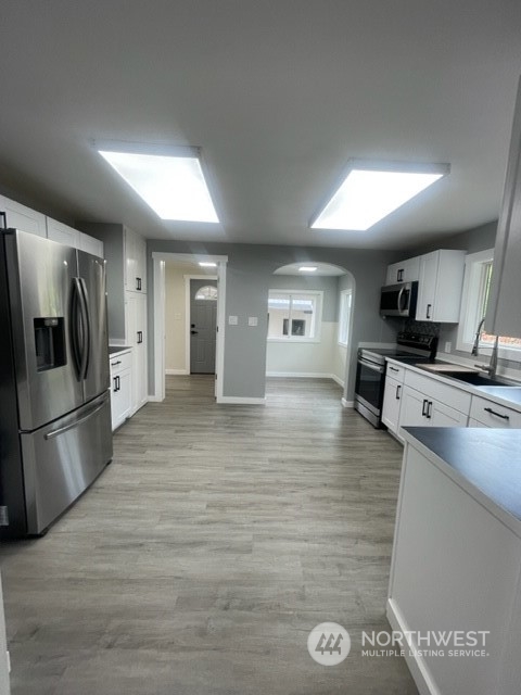 1244 Cedar Street Raymond, WA 98577 - Photo 10 of 25 a kitchen with stainless steel appliances granite countertop a refrigerator a stove a sink and a microwave