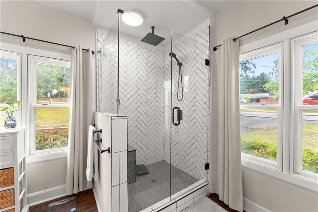 1519 New Hope Church Road Loganville, GA 30052 - Photo 19 of 48 a bathroom with a glass shower door and a window