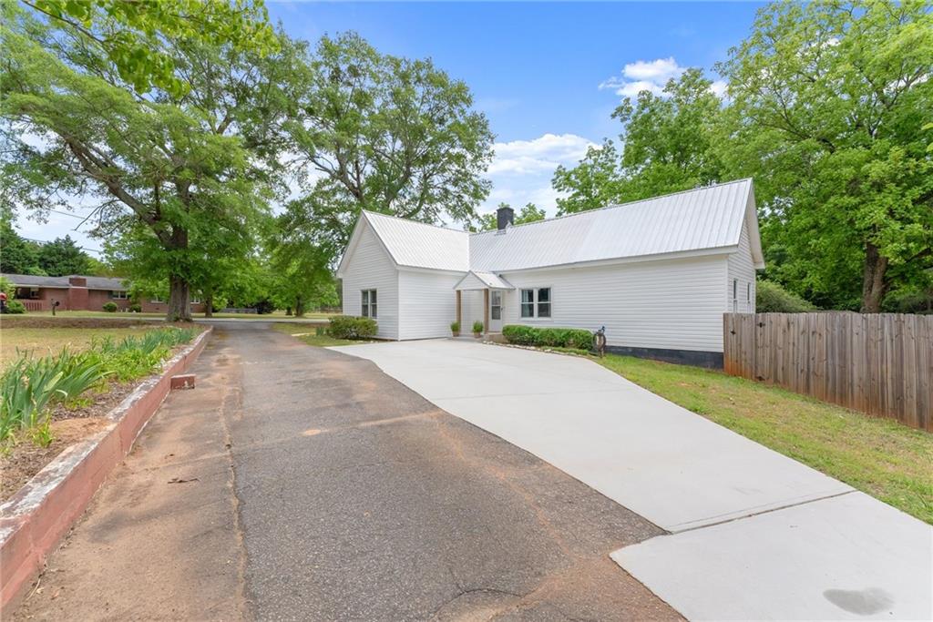 1519 New Hope Church Road Loganville, GA 30052 - Photo 2 of 48 a front view of a house with a yard and garage
