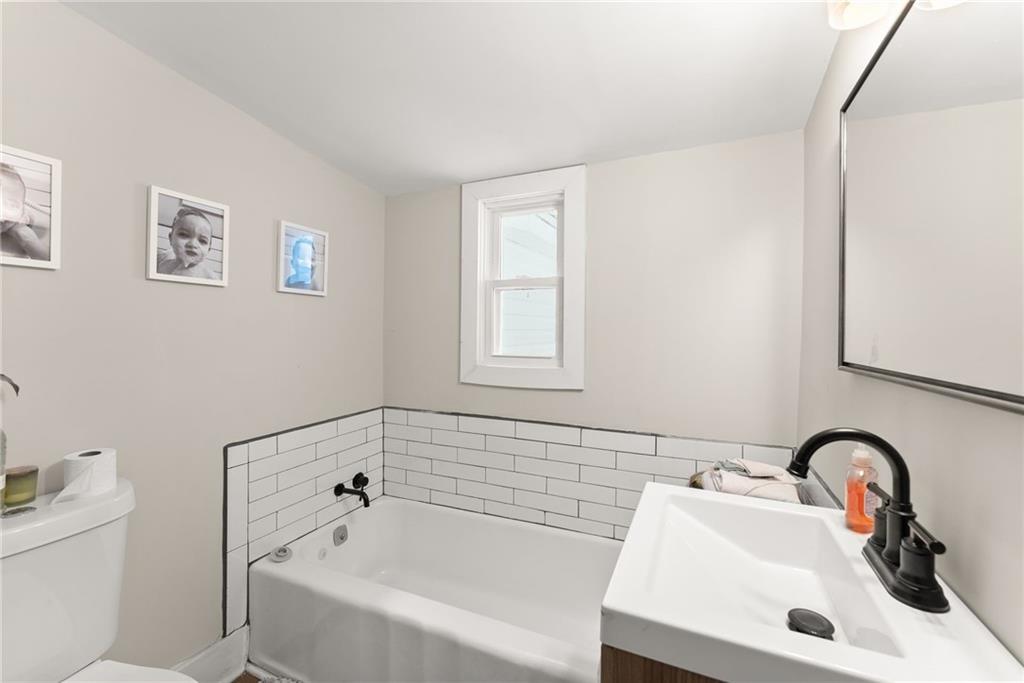 1519 New Hope Church Road Loganville, GA 30052 - Photo 21 of 48 a bathroom with a sink and a bathtub