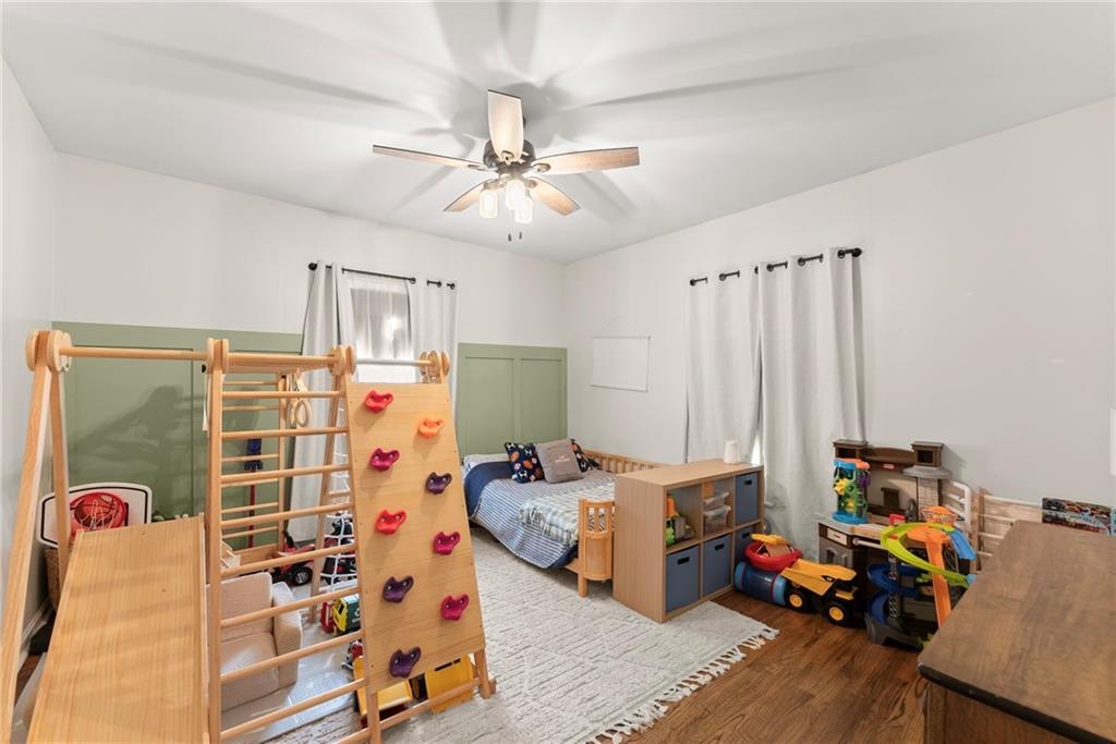1519 New Hope Church Road Loganville, GA 30052 - Photo 23 of 48 a bedroom with furniture and a gym equipment