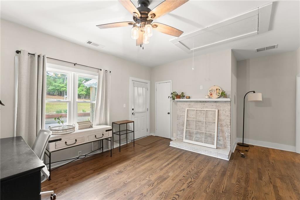 1519 New Hope Church Road Loganville, GA 30052 - Photo 24 of 48 a view of a livingroom with wooden floor and a ceiling fan