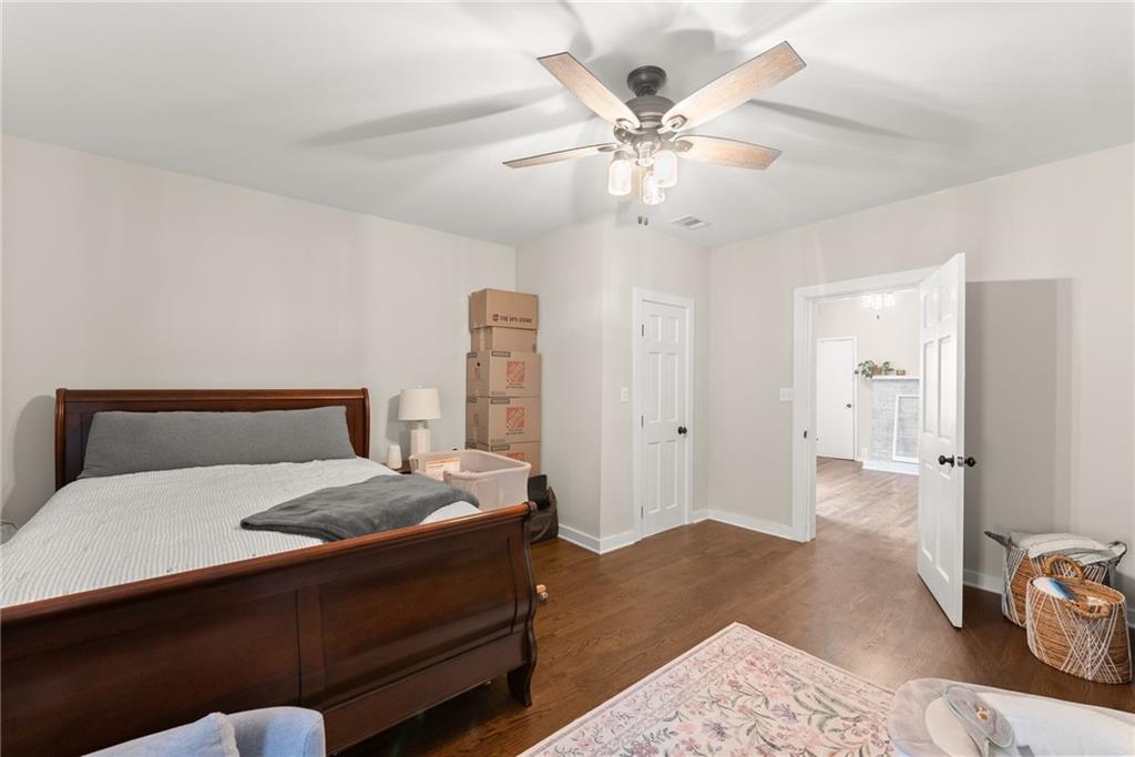 1519 New Hope Church Road Loganville, GA 30052 - Photo 28 of 48 a bedroom with a large bed and a chandelier