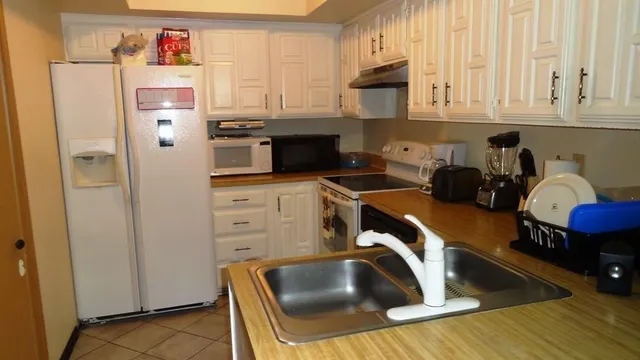 a kitchen with stainless steel appliances a refrigerator and stove