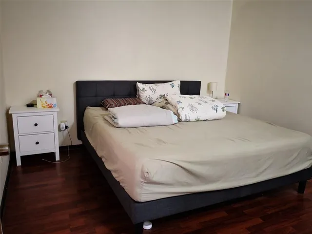 a bedroom with a bed and a chair