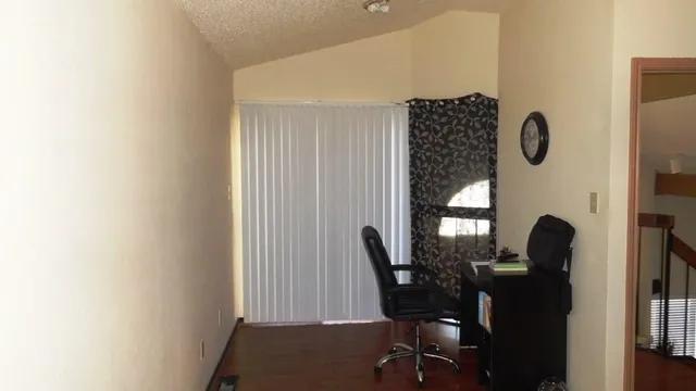 a view of a room with furniture and wooden floor