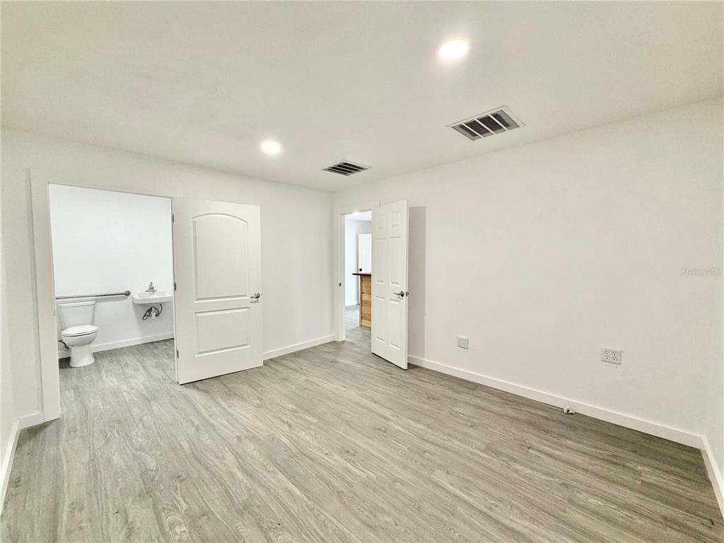 683 North Court Street Bronson, FL 32621 - Photo 13 of 33 wooden floor in an empty room with a window