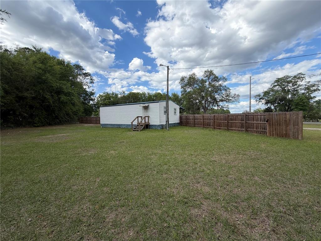 683 North Court Street Bronson, FL 32621 - Photo 19 of 33 a view of a green field with wooden fence