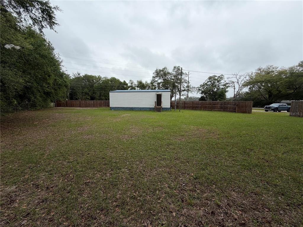 683 North Court Street Bronson, FL 32621 - Photo 26 of 33 a view of a big yard with a house