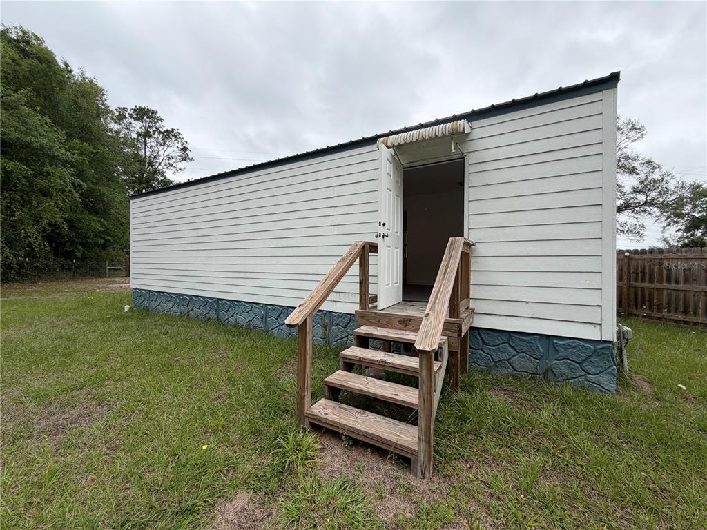 683 North Court Street Bronson, FL 32621 - Photo 27 of 33 a view of a house with backyard and a garden