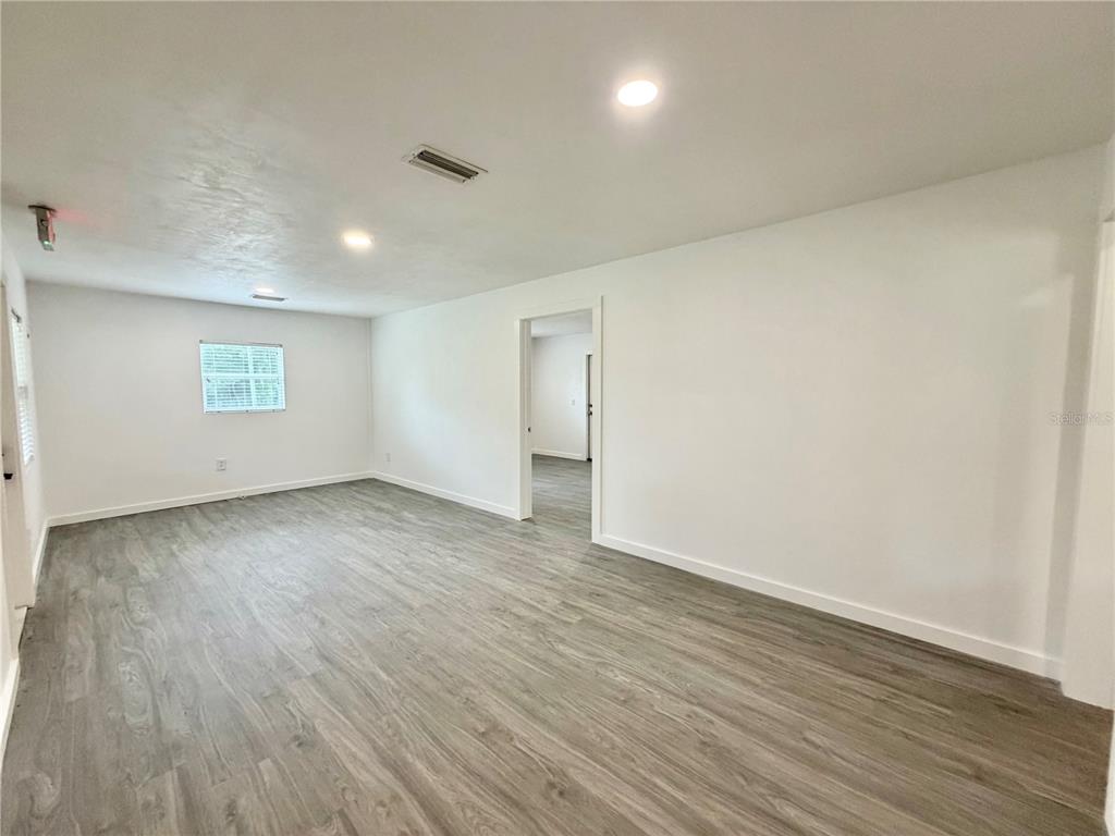 683 North Court Street Bronson, FL 32621 - Photo 7 of 33 an empty room with wooden floor and windows