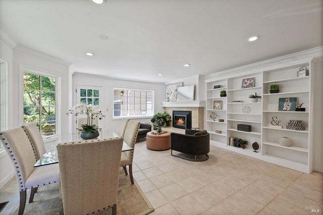 a living room with furniture cabinets and a window