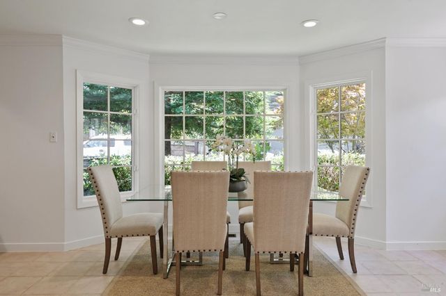 a dining room with furniture window and outside view
