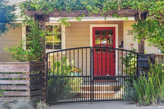 a view of a house with a small yard and plants