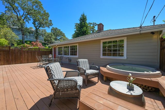 a view of a patio with couches table and chairs and potted plants
