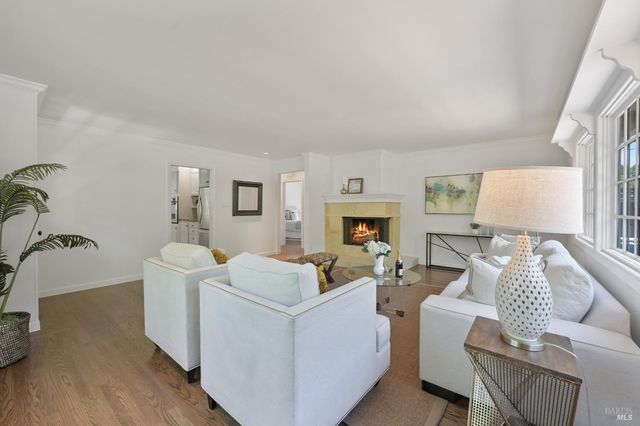 a living room with furniture a window and a fireplace